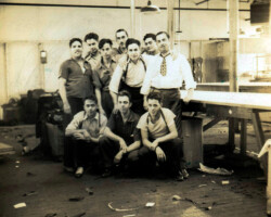 Arnold Gerard, president, Plymouth Sportswear Company, Inc., Fall River, Massachusetts, posing with a group of his employees, 1940.