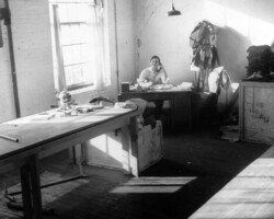 Irving Gerard, shipping clerk, Plymouth Sportswear Company, Inc., Fall River, Massachusetts, posing at his desk, 1940.