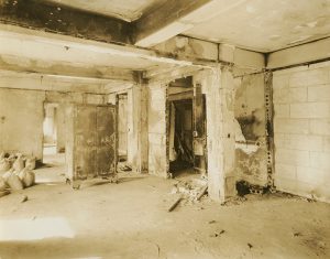 Interior of the Buffington Building, 10 Purchase Street, Fall River, Massachusetts, following the devastating conflagration of February 2, 1928. The view depicts the remains of Room 45, which housed the office and exhibit room of the Fall River Historical Society. The entire collection was lost, sans a selection of important items stored in a Herring, Hall, Marvin safe that can be seen in the photograph.